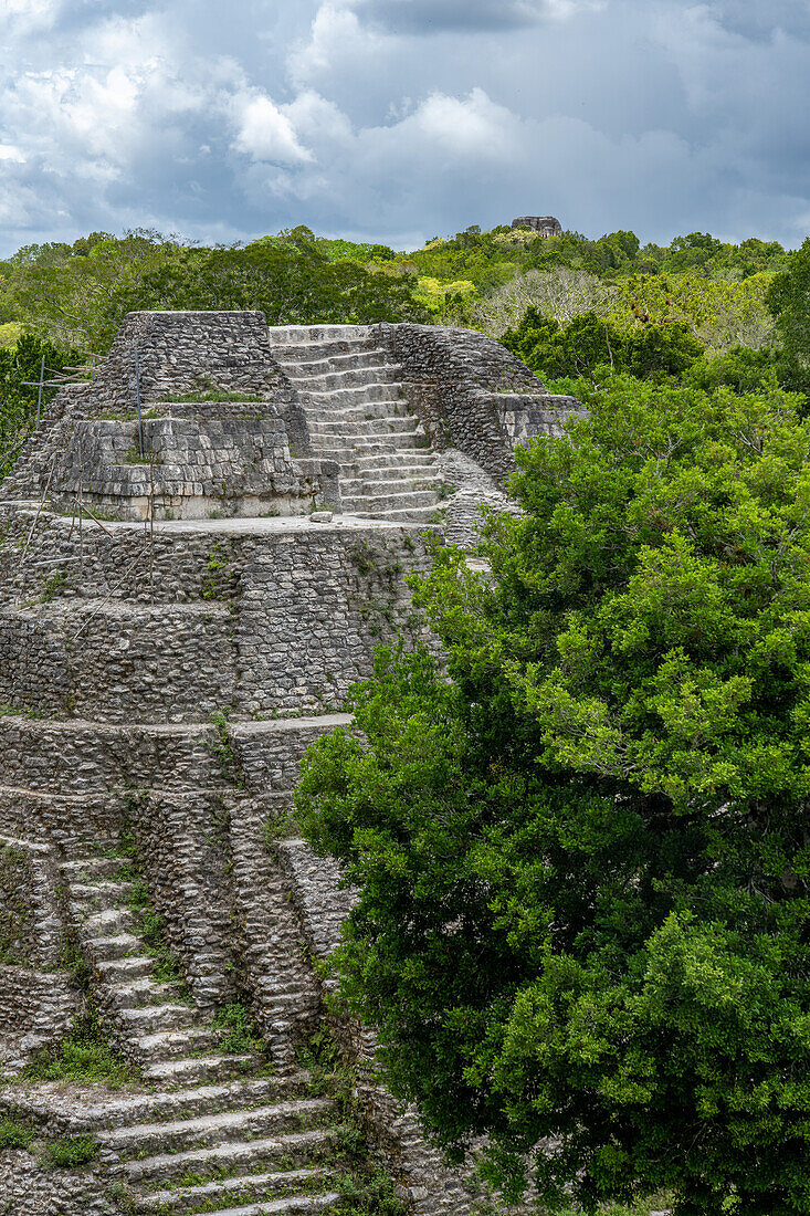 Structure 137,a temple pyramid in the North Acropolis in the Mayan ruins in Yaxha-Nakun-Naranjo National Park,Guatemala. Structure 216,the tallest pyramid in Yaxha,is above the treeline.