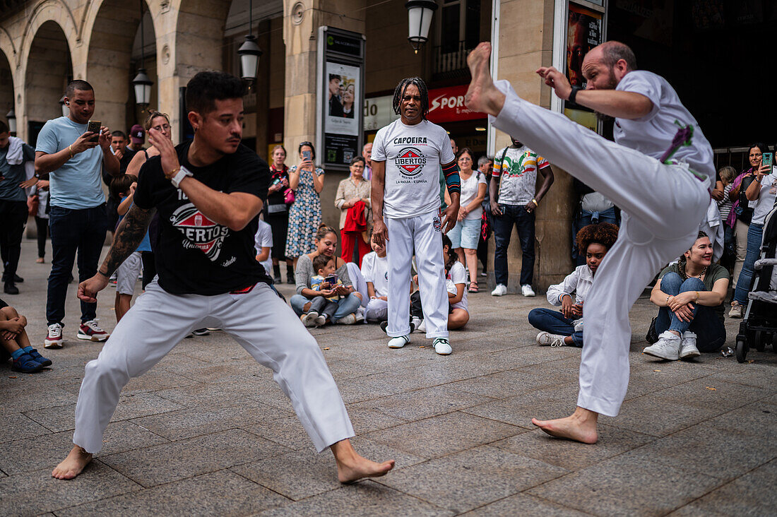 Members of Mestre Branco Capoeira Escola demonstrate in the street during the Fiestas of El Pilar in Zaragoza,Aragon,Spain