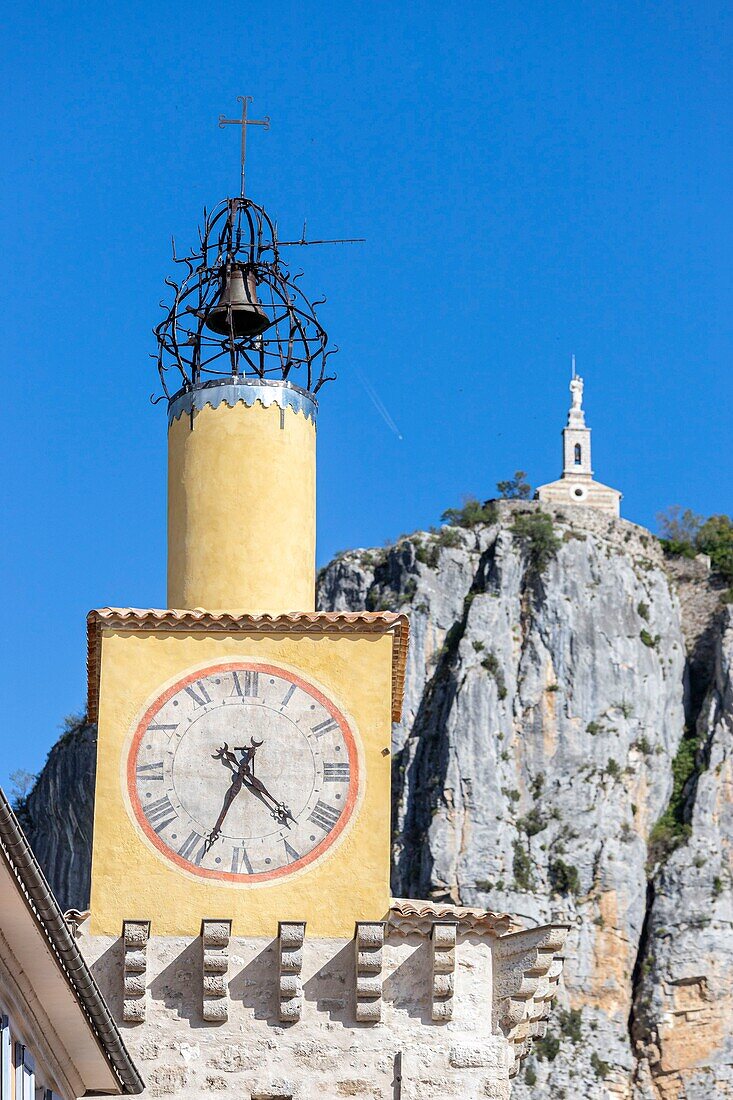 France, Alpes-de-Haute-Provence, Regional Natural Park of Verdon, Castellane, the Clock Tower with in the background the chapel Notre-Dame du Roc at the top of the Roc (911m)