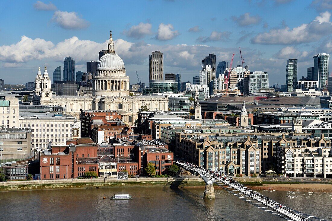 United Kingdom, London, the City, the Millennium Bridge by architect Norman Foster on the Thames river and St. Paul's Cathedral in the background