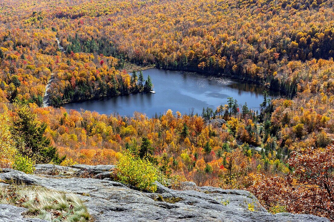 Canada, Province of Quebec, Eastern Townships or Estrie, heart shaped lake in the colors of Indian summer