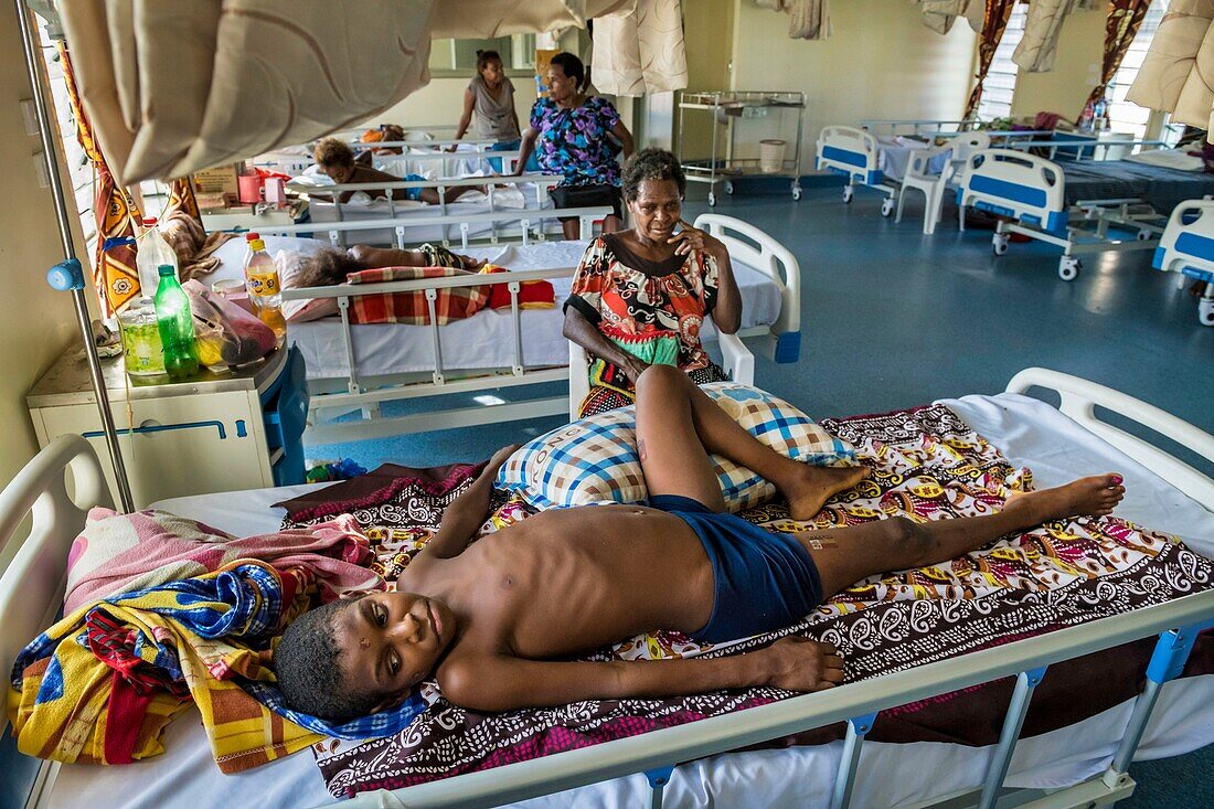 Papua New Guinea, East Sepik Province, Sepik River Region, Wewak Town, Boram Hospital, suspected of having polio, young Nagui Hombi from Numbogu village is paralyzed from all four limbs and unable to move without the help of a family member