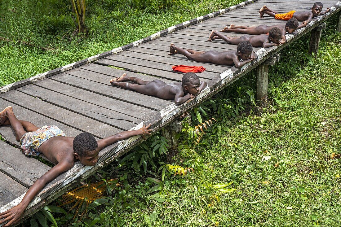 Indonesia, Papua, Asmat district, Per village, pole ceremony, children drying in the sun after bathing