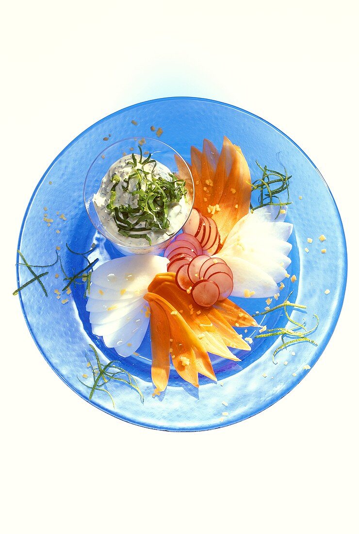 Vegetable carpaccio with sorrel dip on blue glass plate