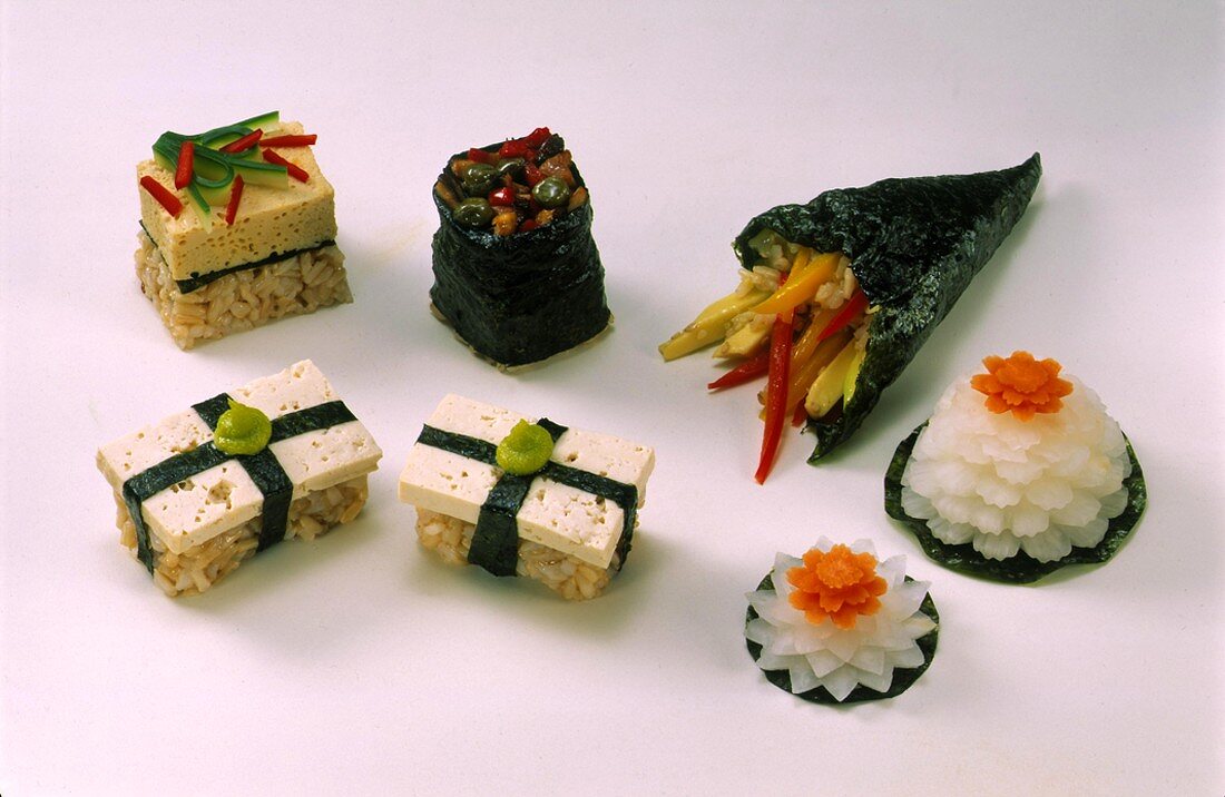 Various sushi and two radish flowers
