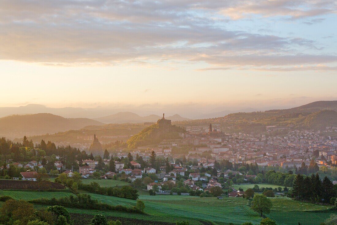 France, Haute Loire, Le Puy en Velay, a stop on el Camino de Santiago, overview of the city with Notre Dame de France statue at the top of on Rocher Corneille, Notre Dame de l'Annonciation Cathedral listed as World Heritage by UNESCO and Saint-Michel d'Aiguilhe on the left