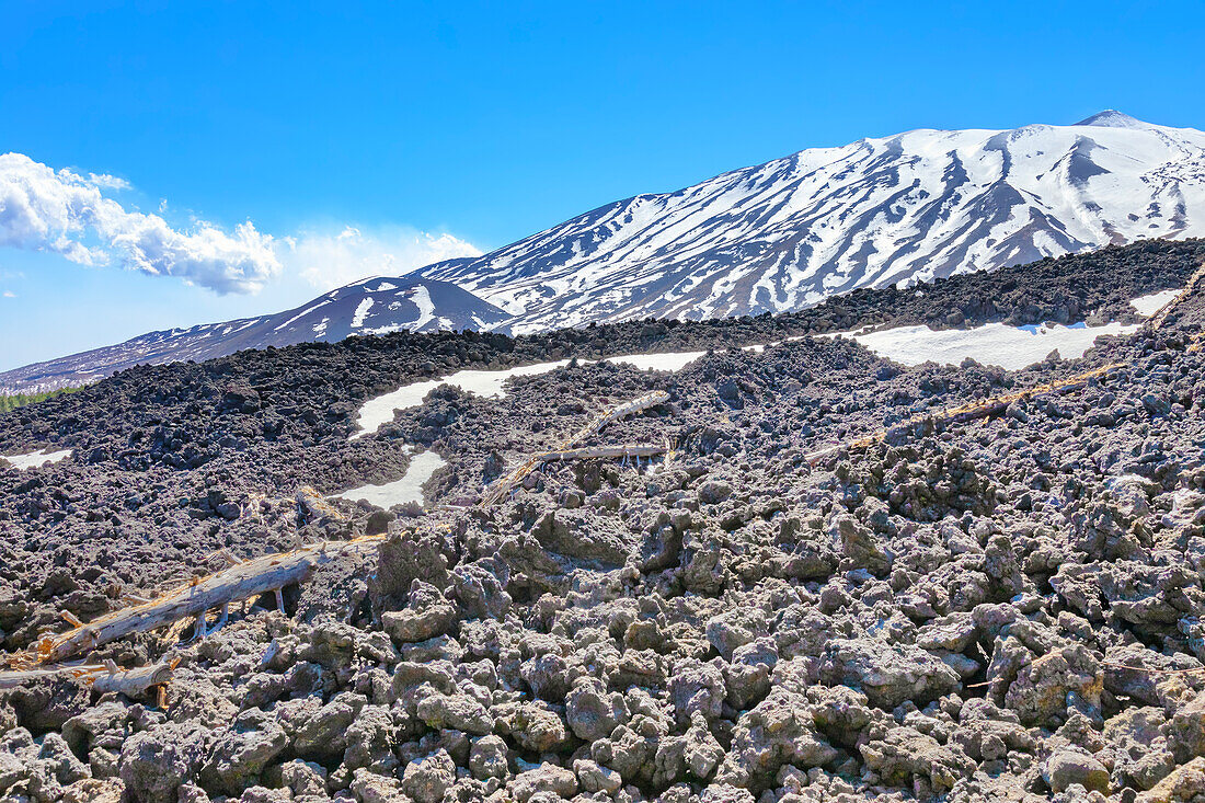 View of lava fields and snow-capped peaks in the distance, Etna, Sicily, Italy, Mediterranean, Europe