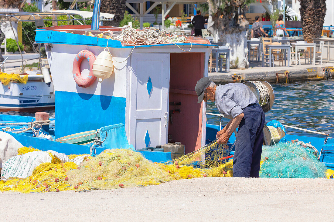 Fisherman working, Livadi, Serifos Island, Cyclades, Greek Islands, Greece, Europe