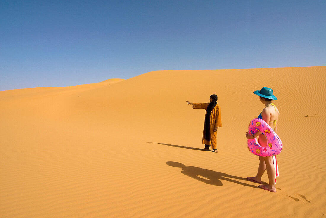 Girl looking for the sea in the Sahara desert, Erg Awbari, Sahara desert, Fezzan, Libya, North Africa, Africa