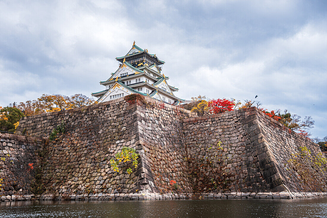 Steep castle moat walls and waters with autumnal colors in fall, Osaka, Hoshu, Japan, Asia