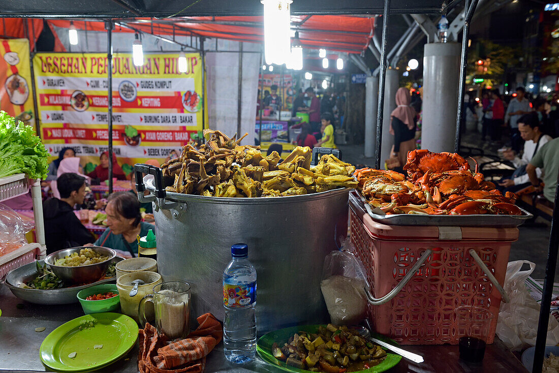 Open-air street side restaurant (lesehan) by night on Malioboro Street, major shopping street in Yogyakarta, Java island, Indonesia, Southeast Asia, Asia