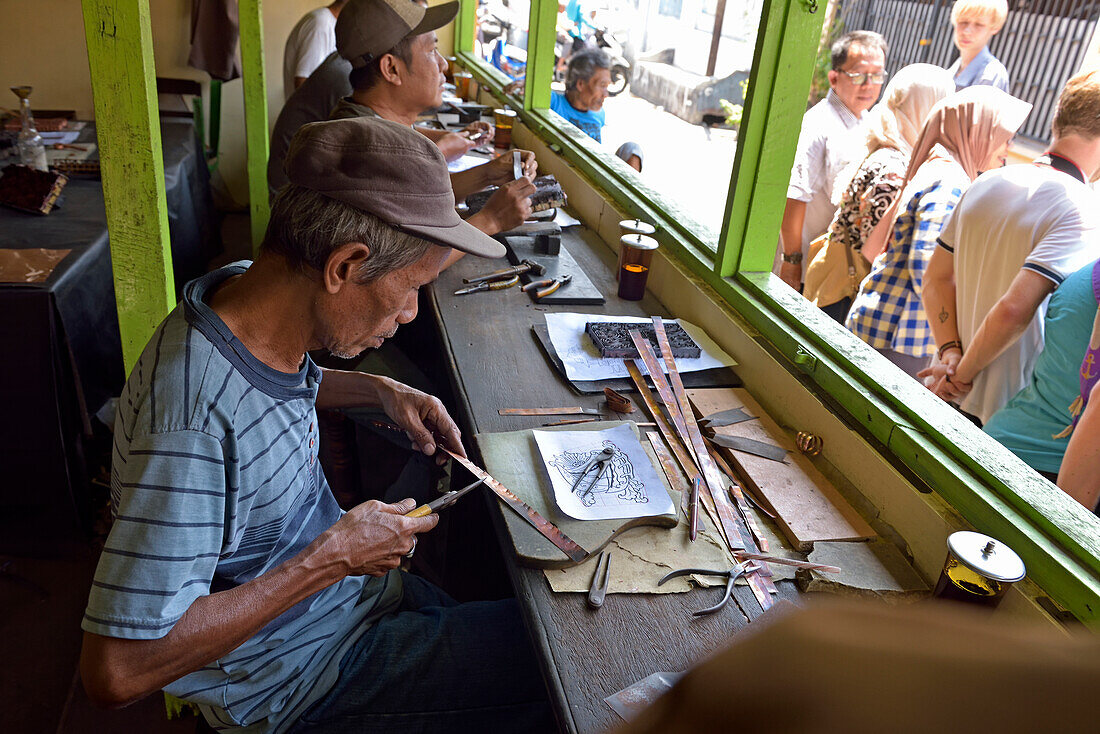 Workshop of copper plate stamps (cap) used to apply wax-resist to make pattern before dyeing in batik process, Sondakan district, Solo (Surakarta), Java island, Indonesia, Southeast Asia, Asia