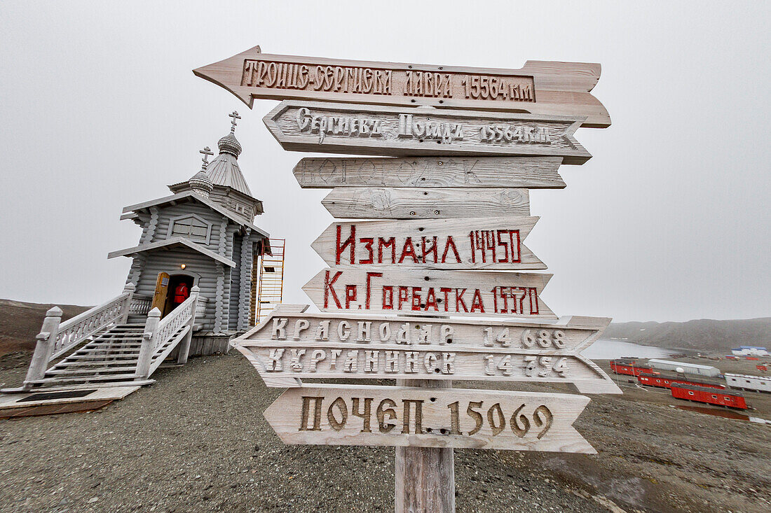 Views signpost and the Trinity Church at Belingshausen Russian Research Station, Antarctica, Southern Ocean, Polar Regions