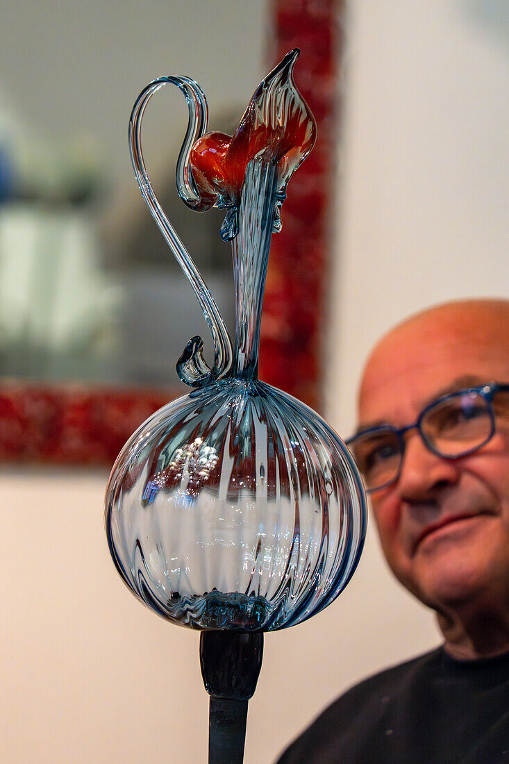 The completed pitcher in a glassblowing demonstration in Venice, Italy.