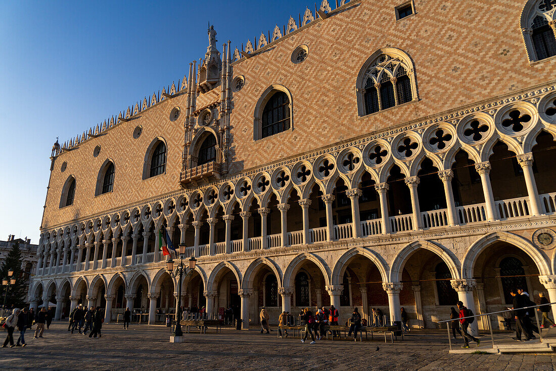 Facade of the Doge's Palace or Palazzo Ducale in late afternoon golden light in Venice, Italy.