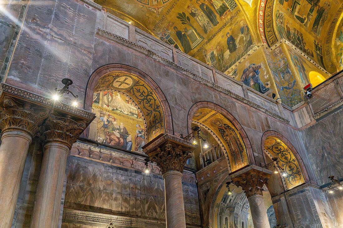 Interior detail of the ceiling with gold mosaics in St. Mark's Basilica in Venice, Italy.