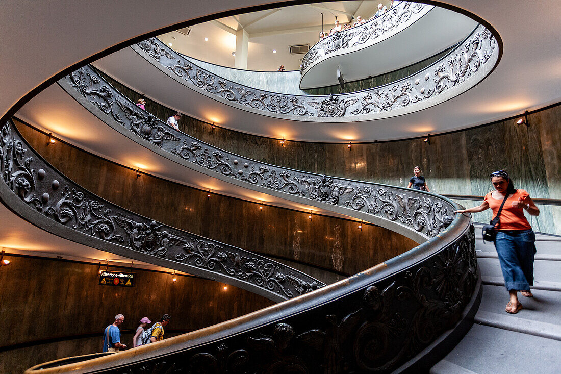 Rome, Italy, July 22 2017, Visitors navigate the elegant helicoidal staircase at the Vatican Museums, enjoying its intricate design and smooth turns.