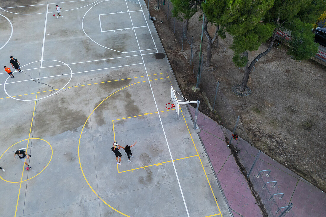 Basketball and soccer exterior courts among trees in city park, Zaragoza, Spain