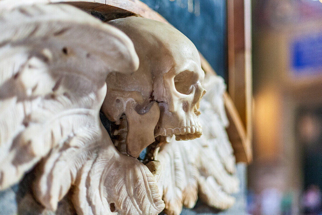 Rome, Italy, July 2017, The striking winged skull sculpture adorns the interior of Santa Maria Sopra Minerva Basilica, showcasing intricate craftsmanship.