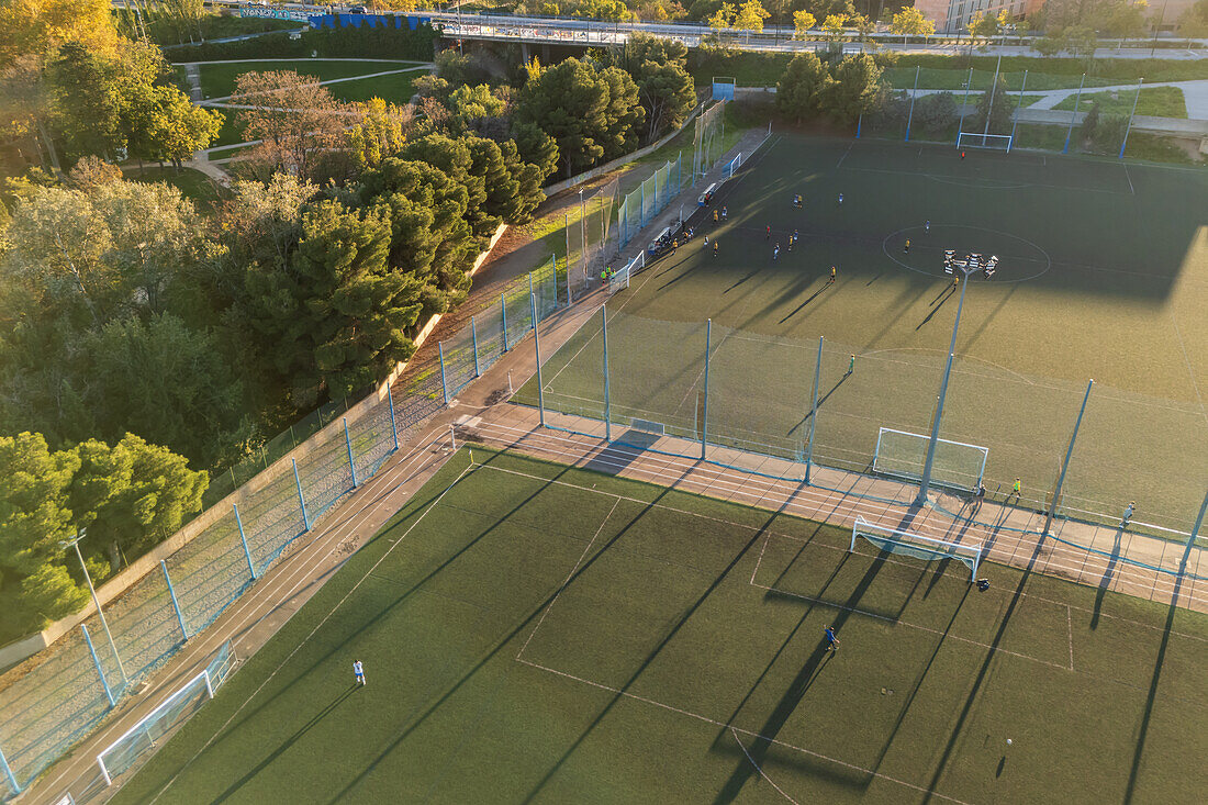 Aerial view of amateur soccer match at sunset