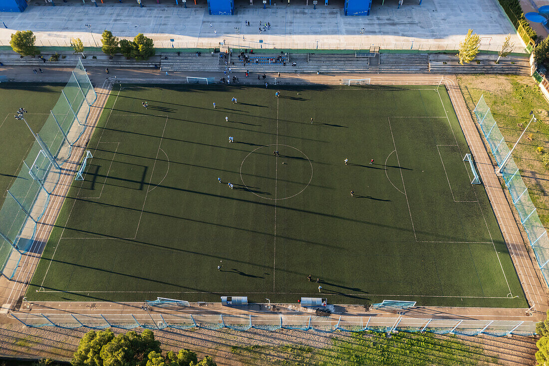 Aerial view of amateur soccer match at sunset