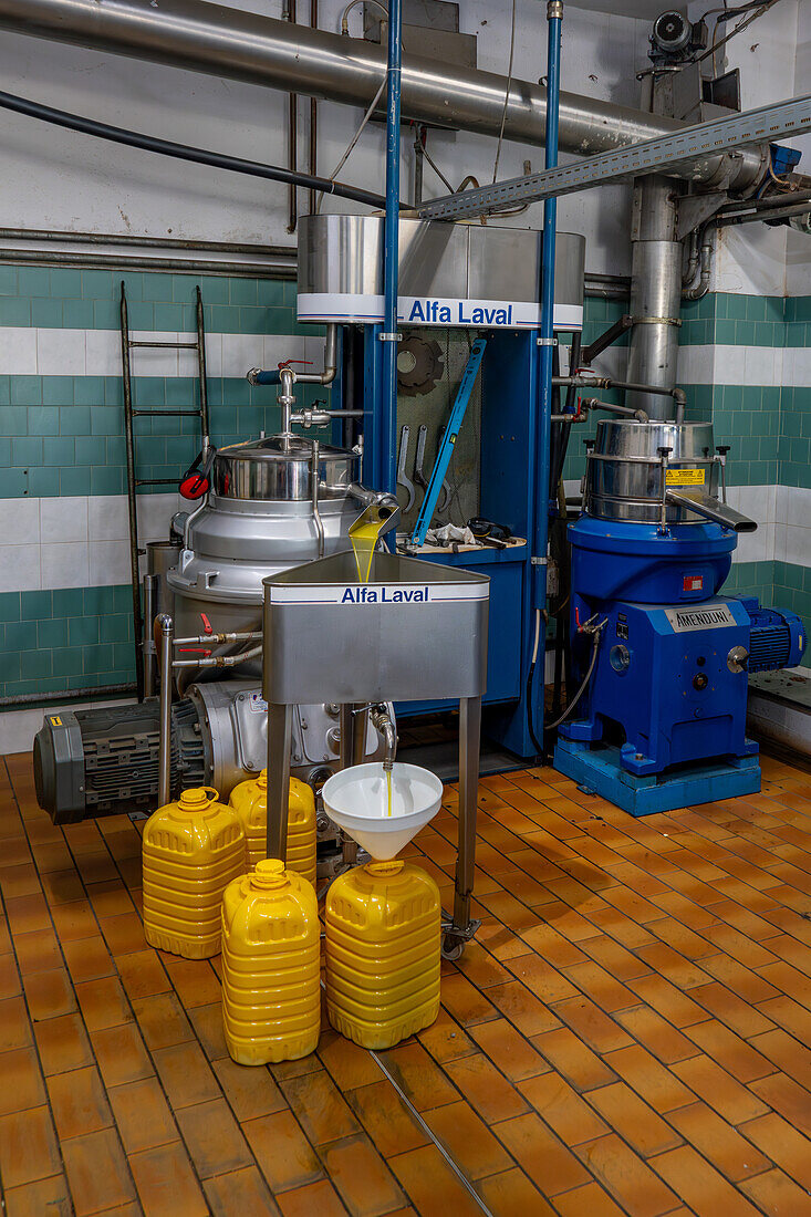 The olive oil passes through a final filter to remove further impurities in an olive oil mill in Italy.