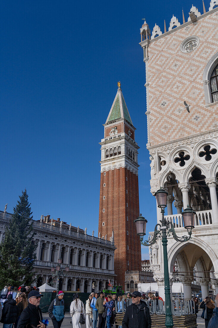 The campanile or bell tower of the Patriarchal Cathedral Basilica of Saint Mark or St. Mark's Basilica in Venice, Italy. At left is the Marciana National Library. At right is the Doge's Palace.