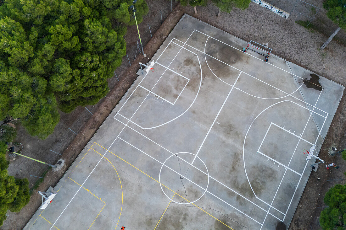 Basketball and soccer exterior courts among trees in city park, Zaragoza, Spain