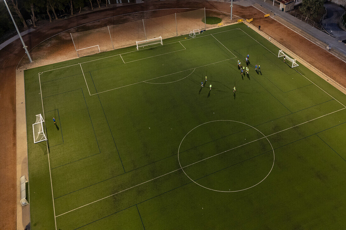 Aerial view of a training in a soccer field at night