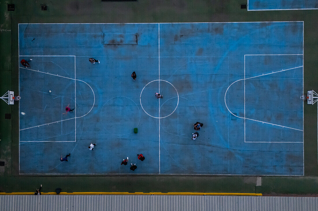 Aerial view of blue basketball and sports courts in school playground