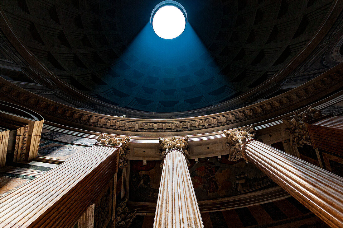 Rome, Italy, July 2017, A beam of sunlight pierces the Pantheon dome, highlighting the majestic Corinthian columns in Rome's historic architecture.