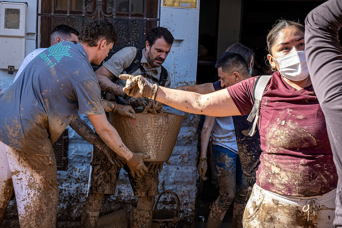 People cleaning. Effects of the DANA floods of October 29, 2024, Convent street, Paiporta, Comunidad de Valencia, Spain