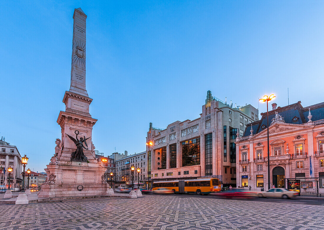 Captivating view of Monumento dos Restauradores, flanked by Teatro Eden and Palacio Foz in Lisbon, Portugal, during the golden hour with a serene evening ambiance.