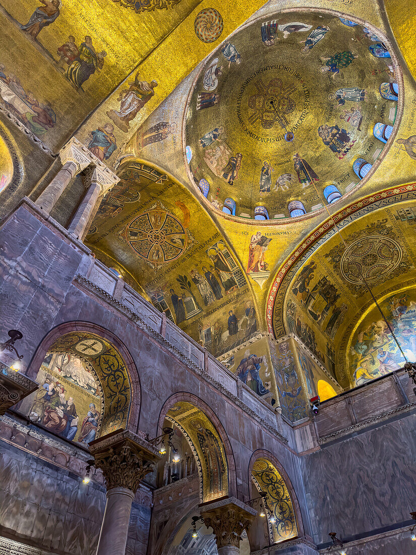 Interior detail of the ceiling with gold mosaics in St. Mark's Basilica in Venice, Italy.