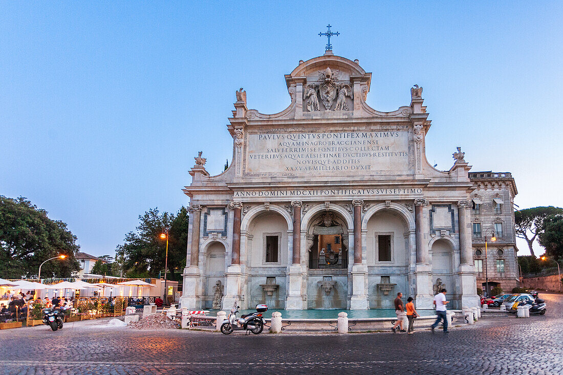 Rome, Italy, July 22 2017, Visitors admire the stunning architecture of the Paola fountain as dusk settles over Rome, creating a magical atmosphere.