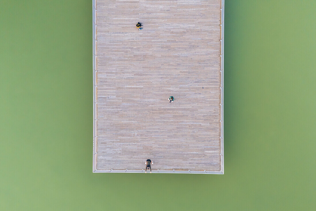 Aerial view of people the wooden dock of an artificial lake