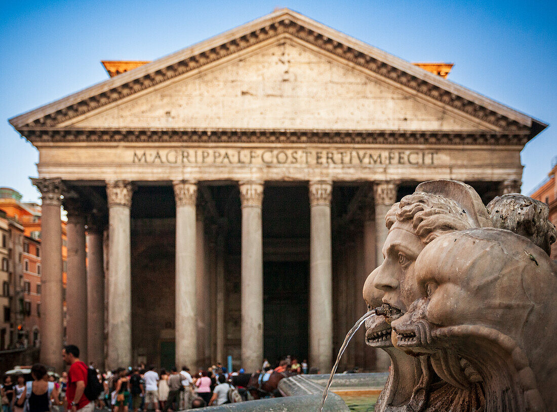 Visitors admire the grand architecture of the Pantheon while enjoying the nearby fountain at Rotonda square in Rome.