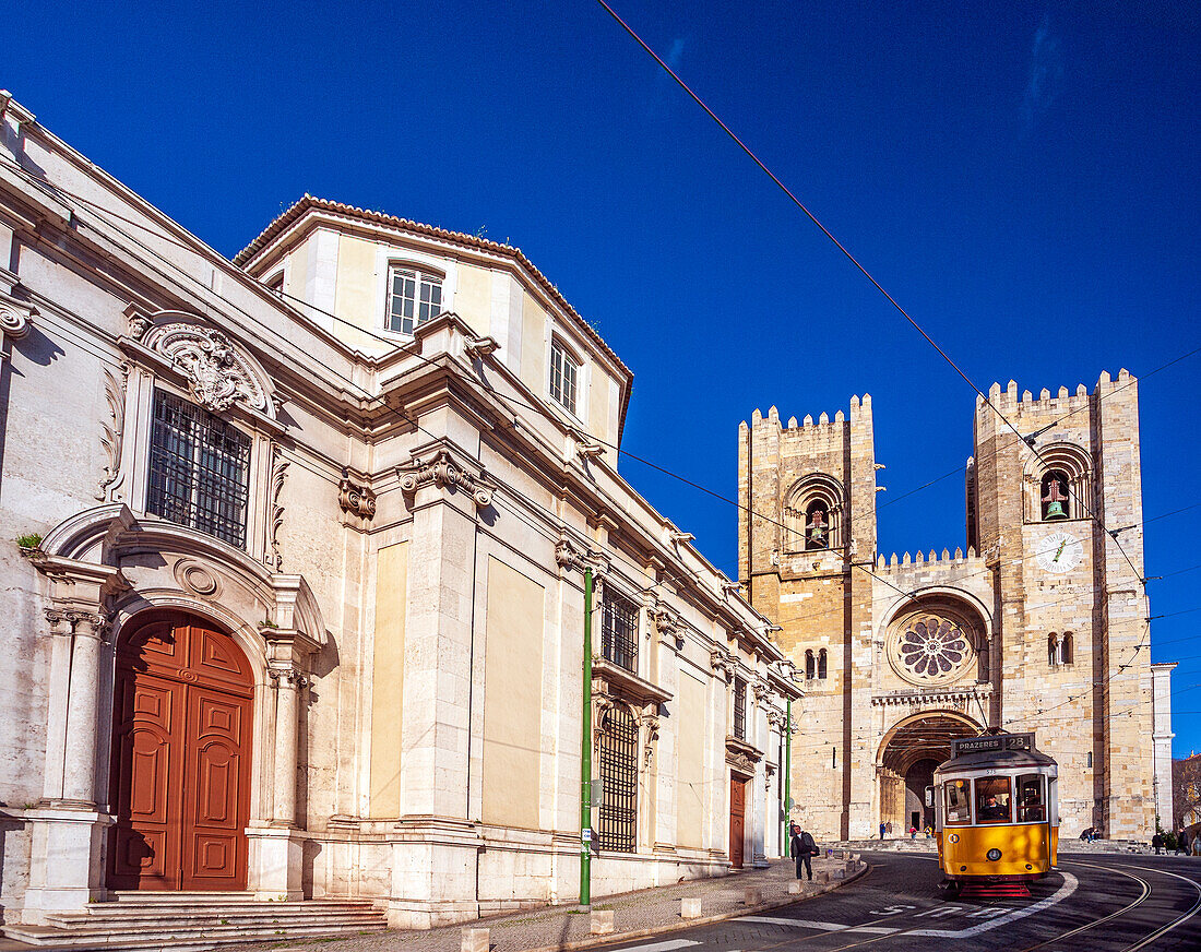 Lisbon, Portugal, March 1 2007, A yellow tram travels past the historic San Antonio de Lisboa church and the majestic Lisbon cathedral in the heart of the city.