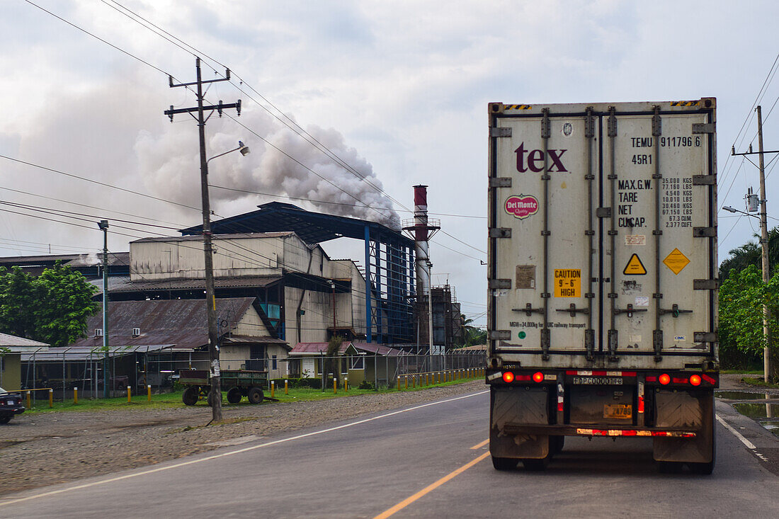 Smoke coming out of a factory chimney and truck on road, Costa Rica