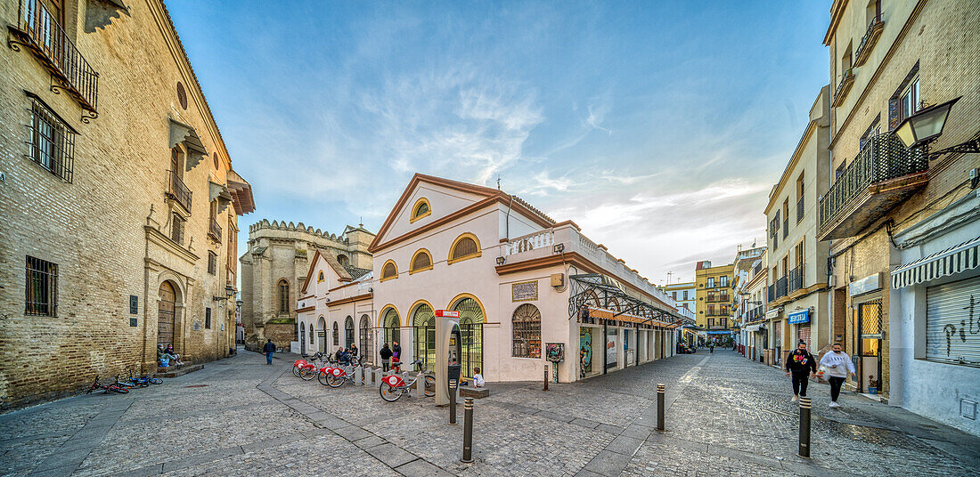 Seville, Spain, Jan 28 2021, Explore the picturesque Plaza de Calderon de la Barca in Sevilla, featuring the historic Mercado de Feria. Captured during sunset, this vibrant scene showcases local architecture and inviting pathways.