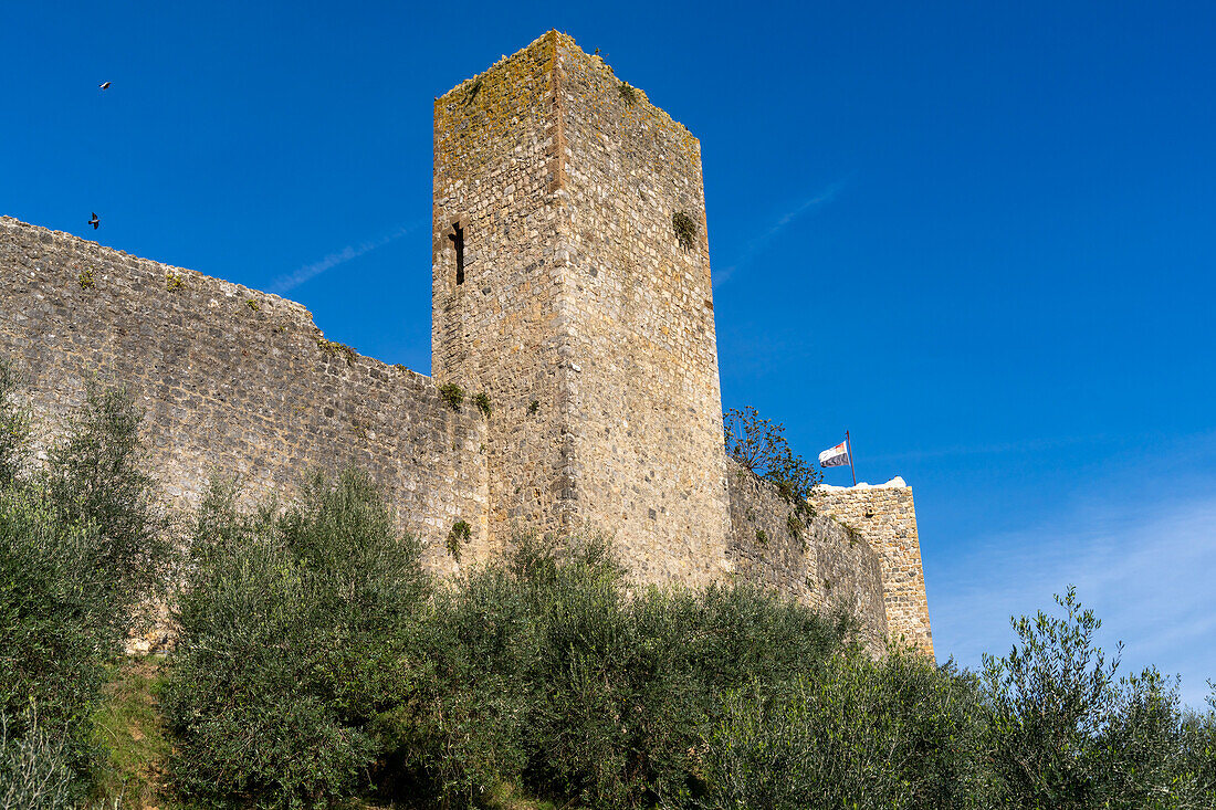 Watchtowers on the wall of the medieval town of Monteriggioni, Sienna, Tuscany, Italy. Viewed from outside.