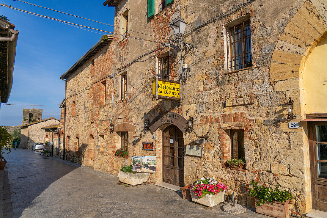 A restaurant on the Piazza Roma in the medieval walled town of Monteriggioni, Sienna Province, Italy.