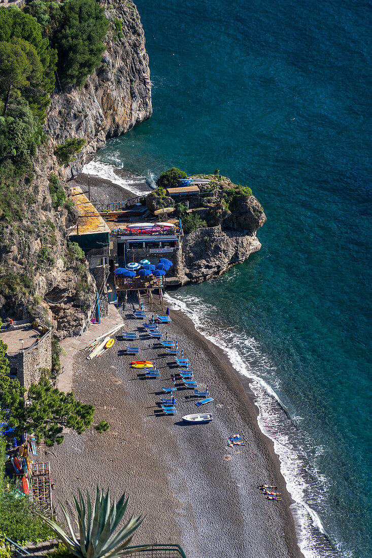 Tourists on the beach of the seaside resort town of Positano, Amalfi Coast, Italy.