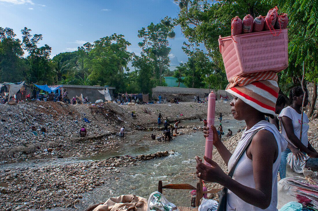 Garbage and street sellers on banks of Riviere de la Cosse, Jacmel, Haiti