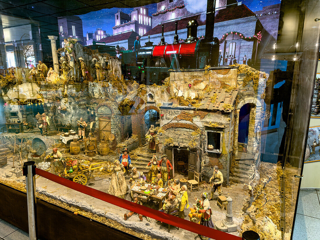 An elaborate traditional presepe or Neapolitan nativity scene on display in the Central Railway Station in Naples, Italy.