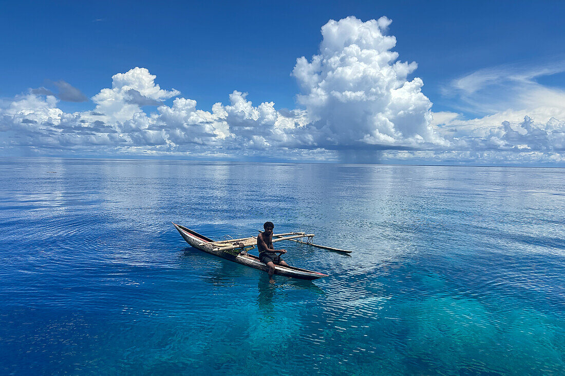 Resident of Vitu Islands in their traditional dugout canoes, Lama Anchorage, New Britain, Papua New Guinea