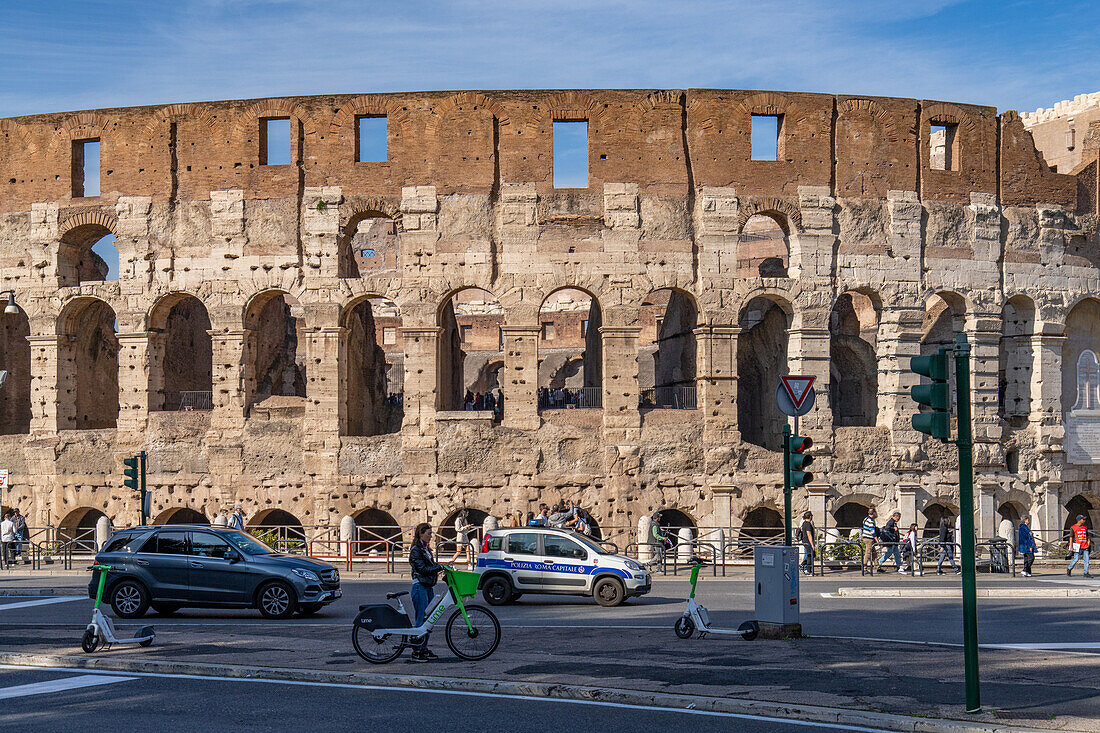 The Via Celio Vibenna and tourists at the ancient Roman Colosseum in Rome, Italy.