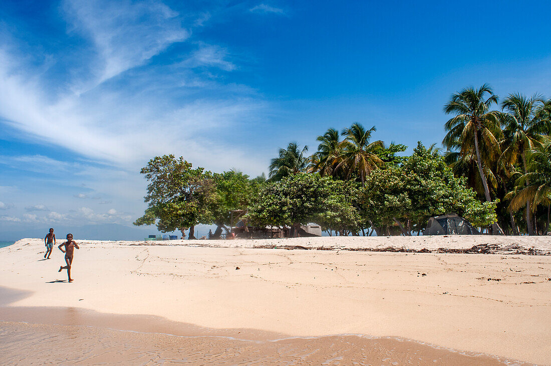 Children playing in the beach on Cayes-à-L’eau, a fishermen islet located northeast of Caye Grand Gosie, Île-à-Vache, Sud Province, Haiti