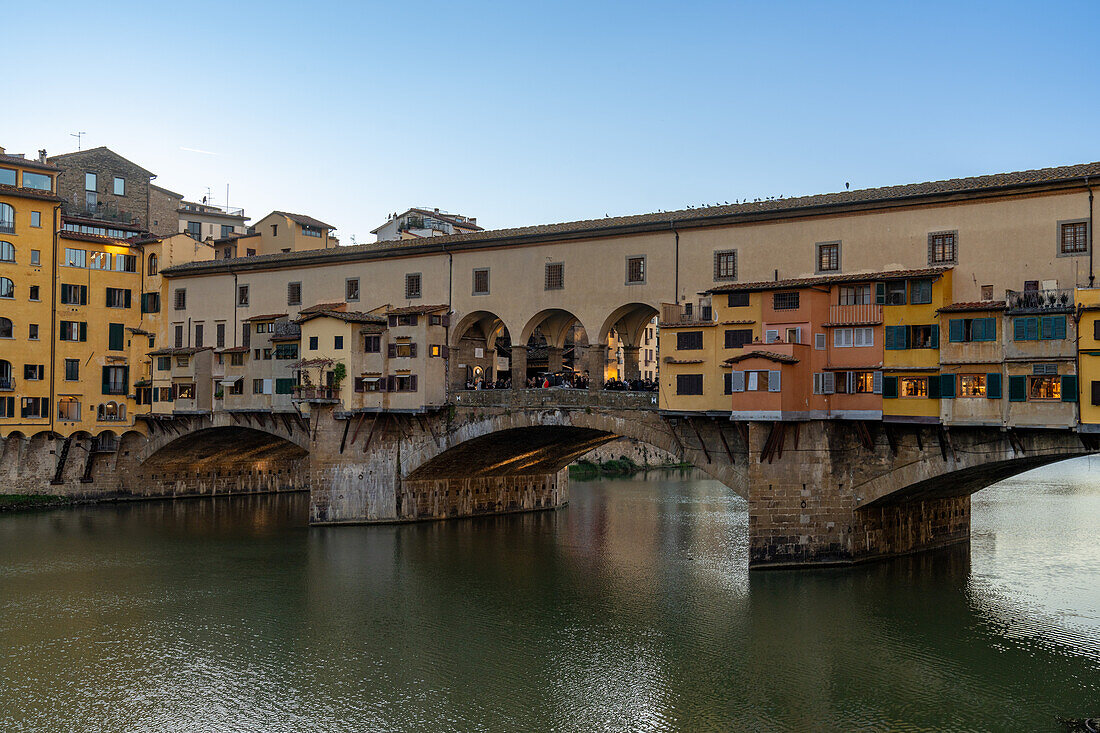 The Ponte Vecchio, a medieval stone arch bridge over the Arno in Florence, Italy.