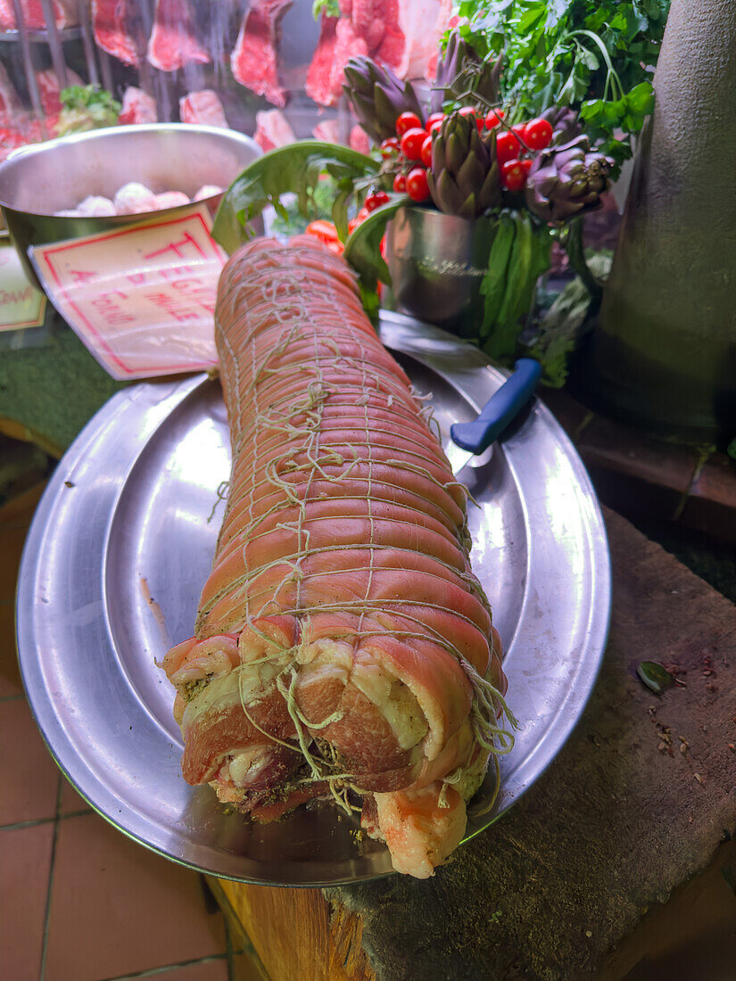 Raw rolled pork or porchetto before cooking at a restaurant serving typical Florentine dishes in Florence, Italy.